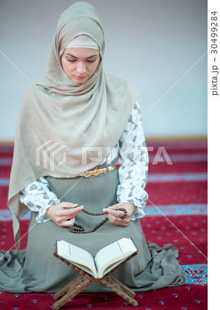 muslim woman praying in mosque muslim woman praying in mosque 30499284