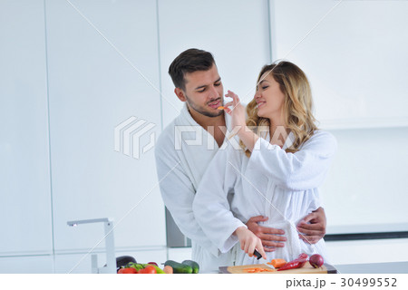 Happy couple cooking breakfast together in the 30499552