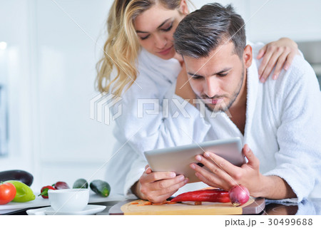 Happy couple cooking breakfast together in the 30499688