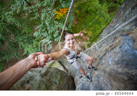 Female climber on high rock wall Female climber on high rock wall 30504934