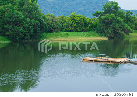 Bamboo raft extending into the water Bamboo raft extending into the water 30505761