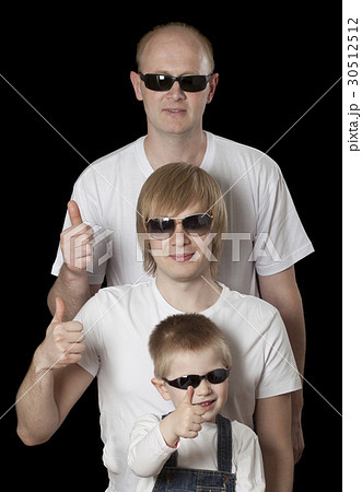 Father and sons giving thumbs up sign 30512512