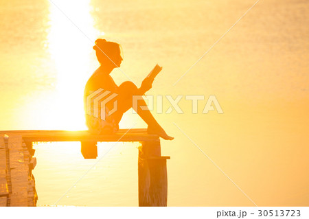 girl reading at the sunset time girl reading at the sunset time 30513723