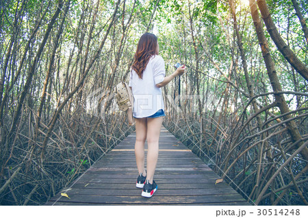 Girl walking alone and hand holding camera. Girl walking alone and hand holding camera. 30514248