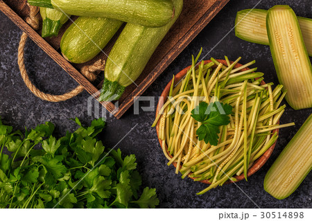 Raw zucchini pasta on dark background. 30514898