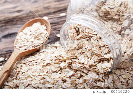 oatmeal is scattered on a wooden table oatmeal is scattered on a wooden table 30516220