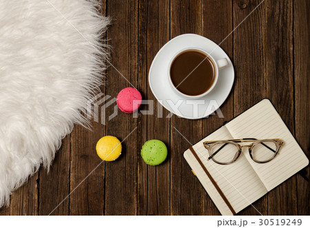 Coffee mug, macarons, notebook and glasses 30519249