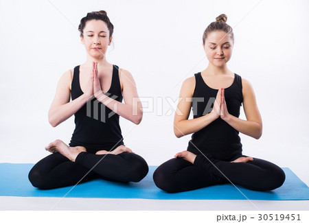 Young man and woman doing yoga and meditating in Young man and woman doing yoga and meditating in 30519451