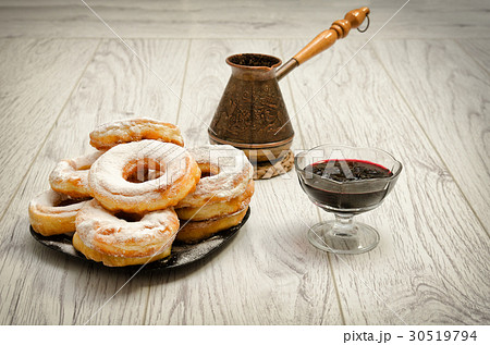 Donuts in powdered sugar, cezve of coffee Donuts in powdered sugar, cezve of coffee 30519794