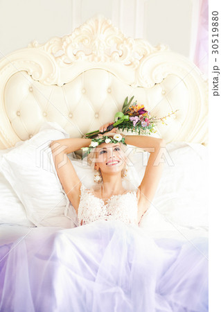 Smiling Model Beautiful Woman Lying on the Bed 30519880