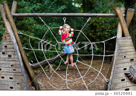 Child having fun on school yard playground Child having fun on school yard playground 30520991