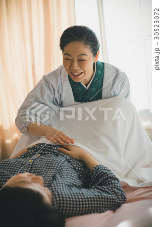woman during pregnancy or shortly after childbirth woman during pregnancy or shortly after childbirth 30523072