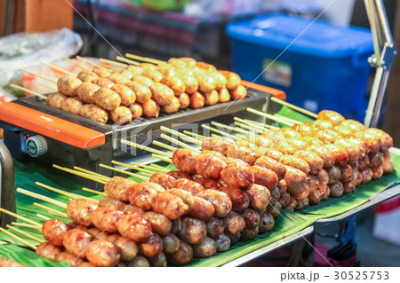 Thai street food variety of grilled e-san sausage. 30525753
