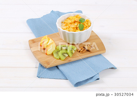 corn flakes with milk and fresh fruit 30527034