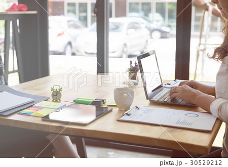 Businesswoman typing on laptop at workplace. 30529212