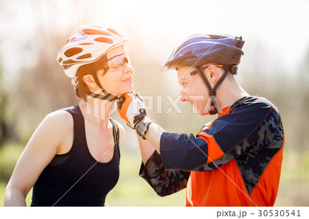 Bicyclists in helmets at park 30530541