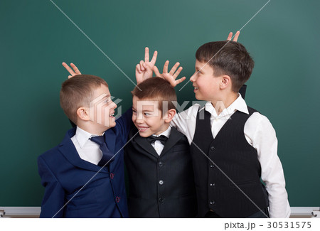 elementary school boy fooling around on blackboard elementary school boy fooling around on blackboard 30531575