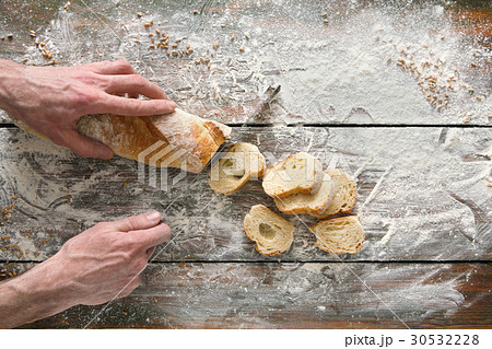 Bakery concept background. Hands cutting bread Bakery concept background. Hands cutting bread 30532228