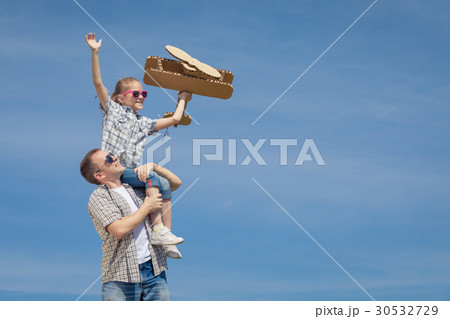Father and daughter playing with toy airplane Father and daughter playing with toy airplane 30532729
