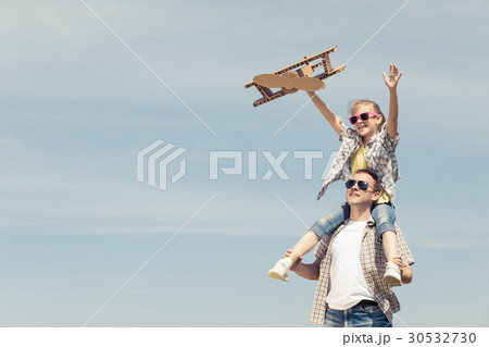 Father and daughter playing with toy airplane Father and daughter playing with toy airplane 30532730