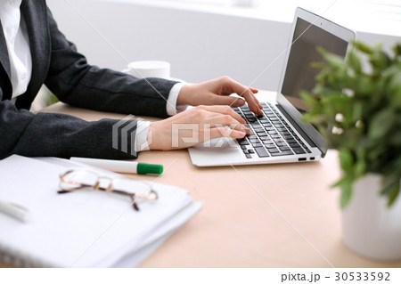 Close up of business woman hands typing on laptop 30533592