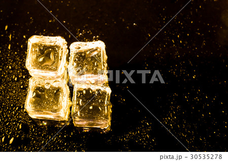 ice cubes and water drop on light golden. 30535278