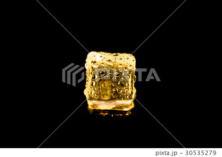 ice cubes and water drop on light golden. 30535279