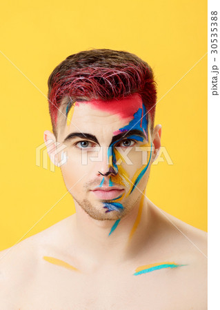 portrait of young man with colored face paint on portrait of young man with colored face paint on 30535388