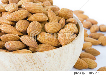 Almond in wooden bowl on white background isolated Almond in wooden bowl on white background isolated 30535508
