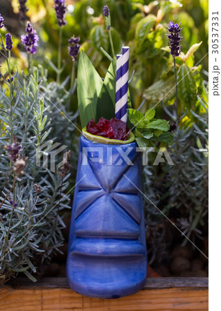 Tropical cocktails served in a tiki style glass in 30537331