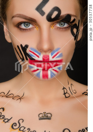 Inscriptions and flag of england on woman's face 30537738