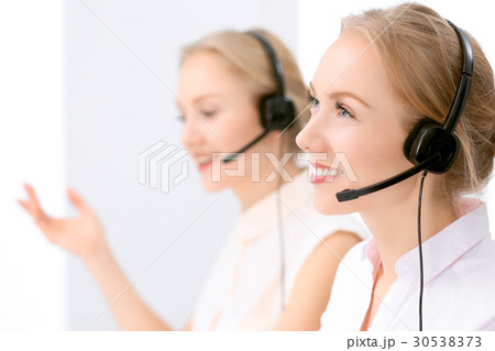 Call center. Focus on beautiful blonde woman in 30538373