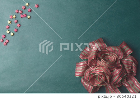 Decorative red and gree ribbon on old green board 30540321