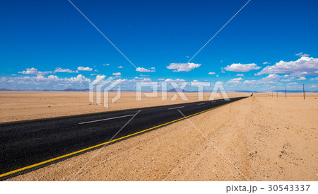 vibrant image of highway and blue cloudy sky vibrant image of highway and blue cloudy sky 30543337