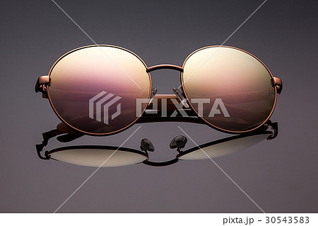 Stylish polarized mirrored sunglasses on grey. 30543583
