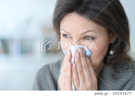 Cold young woman with a handkerchief 30543877