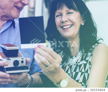 Photo Gradient Style with Close up couple checking instant camera image Photo Gradient Style with Close up couple checking instant camera image 30554804