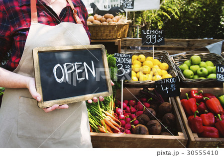 Greengrocer selling organic fresh agricultural product at farmer market Greengrocer selling organic fresh agricultural product at farmer market 30555410