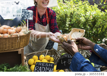 Greengrocer selling organic fresh agricultural product at farmer market Greengrocer selling organic fresh agricultural product at farmer market 30555593