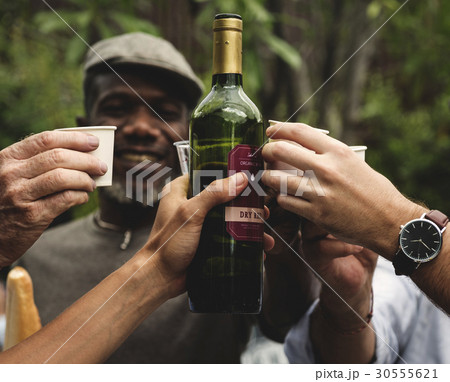 Group of men drinking local red wine together Group of men drinking local red wine together 30555621
