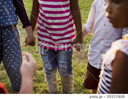 Group of kindergarten kids friends holding hands playing at park 30555806