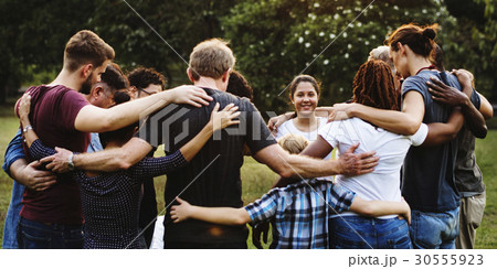 Group of people huddle together in the park 30555923