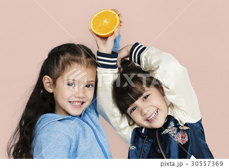 Two girls and fresh orange Two girls and fresh orange 30557369