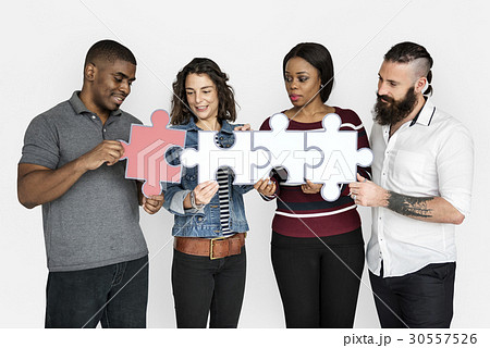 People are holding puzzle together People are holding puzzle together 30557526