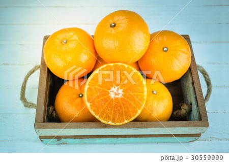 Fresh whole orange fruits and sliced orange Fresh whole orange fruits and sliced orange 30559999