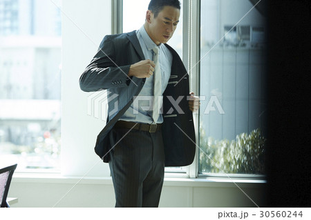 the businessman is wearing the suit. 30560244