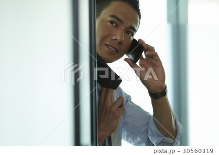 the businessman is making a phone call. 30560319