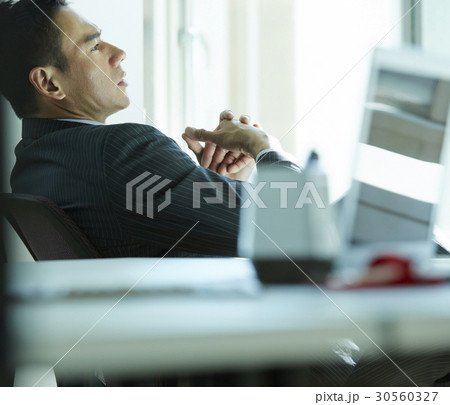the businessman sitting on chair is thinking. the businessman sitting on chair is thinking. 30560327
