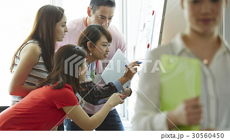Four of five people is looking at and writing something Four of five people is looking at and writing something 30560450