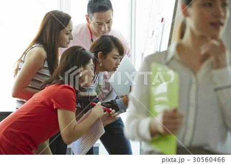 Four of five people are concentrating on something Four of five people are concentrating on something 30560466